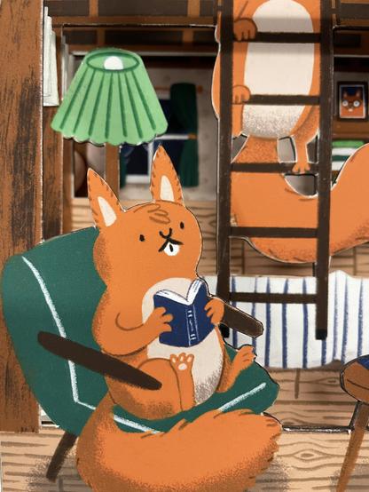 Closeup of the squirrel sitting on an armchair, reading and looking unperturbed about the terror their housemate is currently experiencing