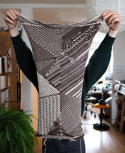 A knitted fabric with a beige/brown cellular automata pattern