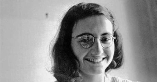 Black and white photo of Margot Frank smiling at the camera.