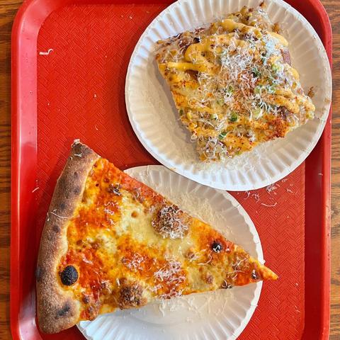 A slice of spicy vodka pizza and a slice of elote pizza from Diamond Slice.