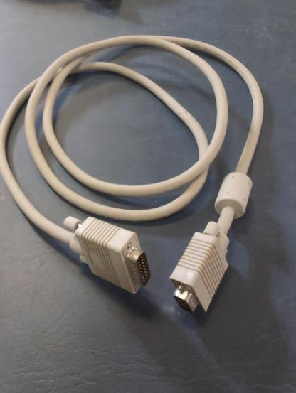 An off-white cable coiled on a blue background. It has two male D-sub connectors.