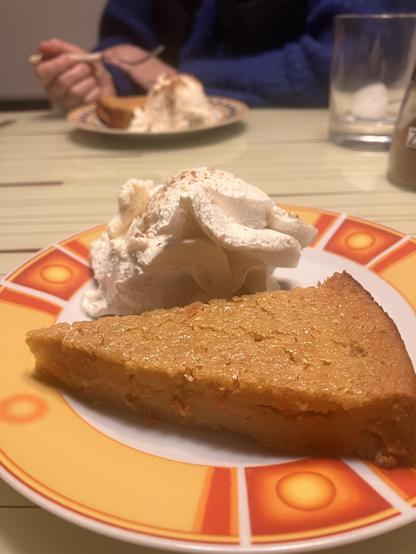 Ein Stück Karotten-Mochi-Kuchen neben einer Kugel Vanille-Eis.