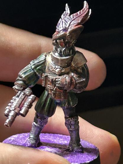 The last with a gas mask and a feather in his cap