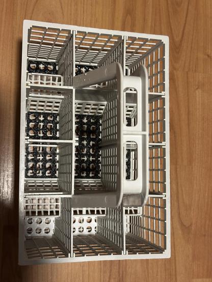 Top view of a dish washer cutlery basket, with 3D printed bottom.