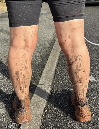 After photo. You can’t see Emily’s shoes through the mud. The mud is caked all the way up to her knees.