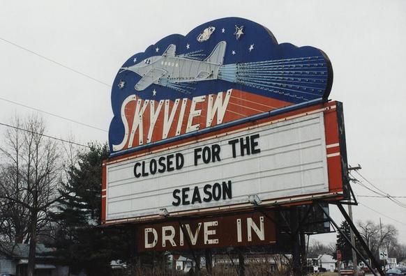 Neon sign foe the Skyview Drive In, with a marquee below that reads "CLOSED FOR THE SEASON".