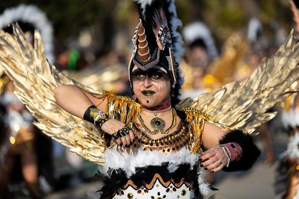 A female in costume at a carnival.