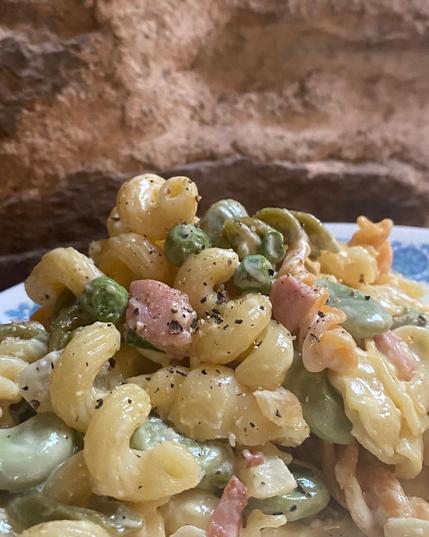 close up of broad beans, peas, onions, & mint pasta