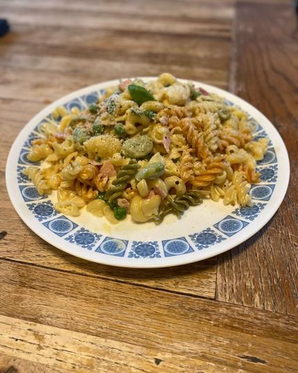 broad beans, peas, onions, & mint on plate on a wooden table