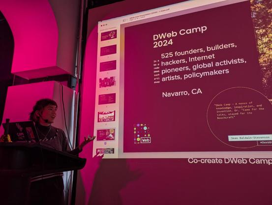 Mai telling the story of DWeb Camp