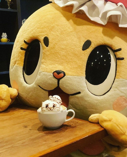 Baby Fairy Mascot with cup holding an marshmallow shapped like itself.