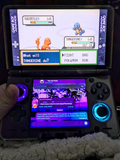 Pokémon LeafGreen for the Gameboy Advance running on a dual screen handheld device called the AYN Thor. The messaging client Telegram is on the bottom screen.