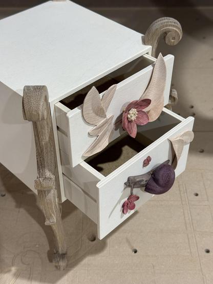 The same box with the drawers slightly open and viewed at an oblique angle