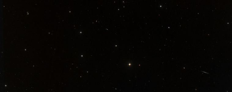 A photo captured by a space telescope from the linked website, typically showing a wide image of distant galaxies with stars and interstellar gas.