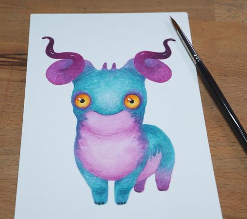 watercolour painting of a turquoise blue monster with pink horns and a pink tummy. It has large orange eyes and a sweet gentle smile.