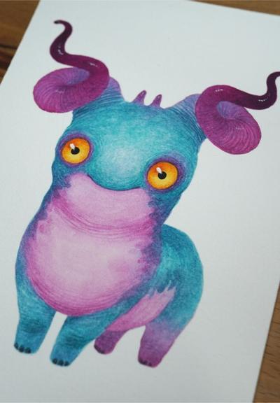 watercolour painting of a turquoise blue monster with pink horns and a pink tummy. It has large orange eyes and a sweet gentle smile.