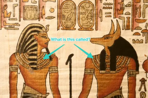 an annotated illustration of Maashes and Anubis  and some hieroglyphs above them. the annotation says "what is this called?" and points to a large piece of curved jewlery that hangs over their shoulders, as if wearing a two foot circle of cloth that their head is poking through.