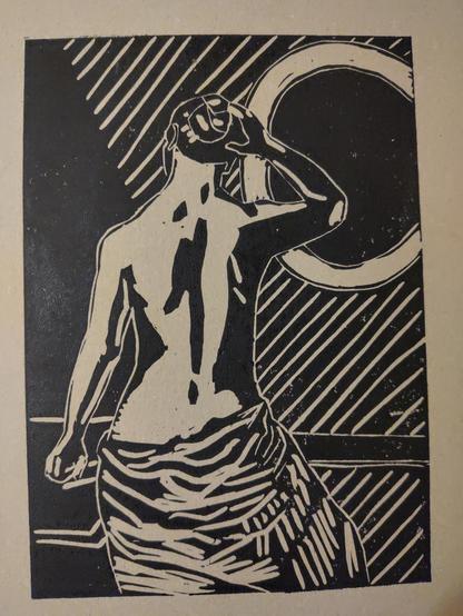 Linocut: Young nude woman is posing in front of a mirror. The woman is seen from behind. She has her right hand bent to touch her head, and the left hand extended to rest on a table. She is draped in a sheet around her hips. Light is streaming into the room creating stark shadows. The mirror is left as a black surface here (not so in the painting it's based on)