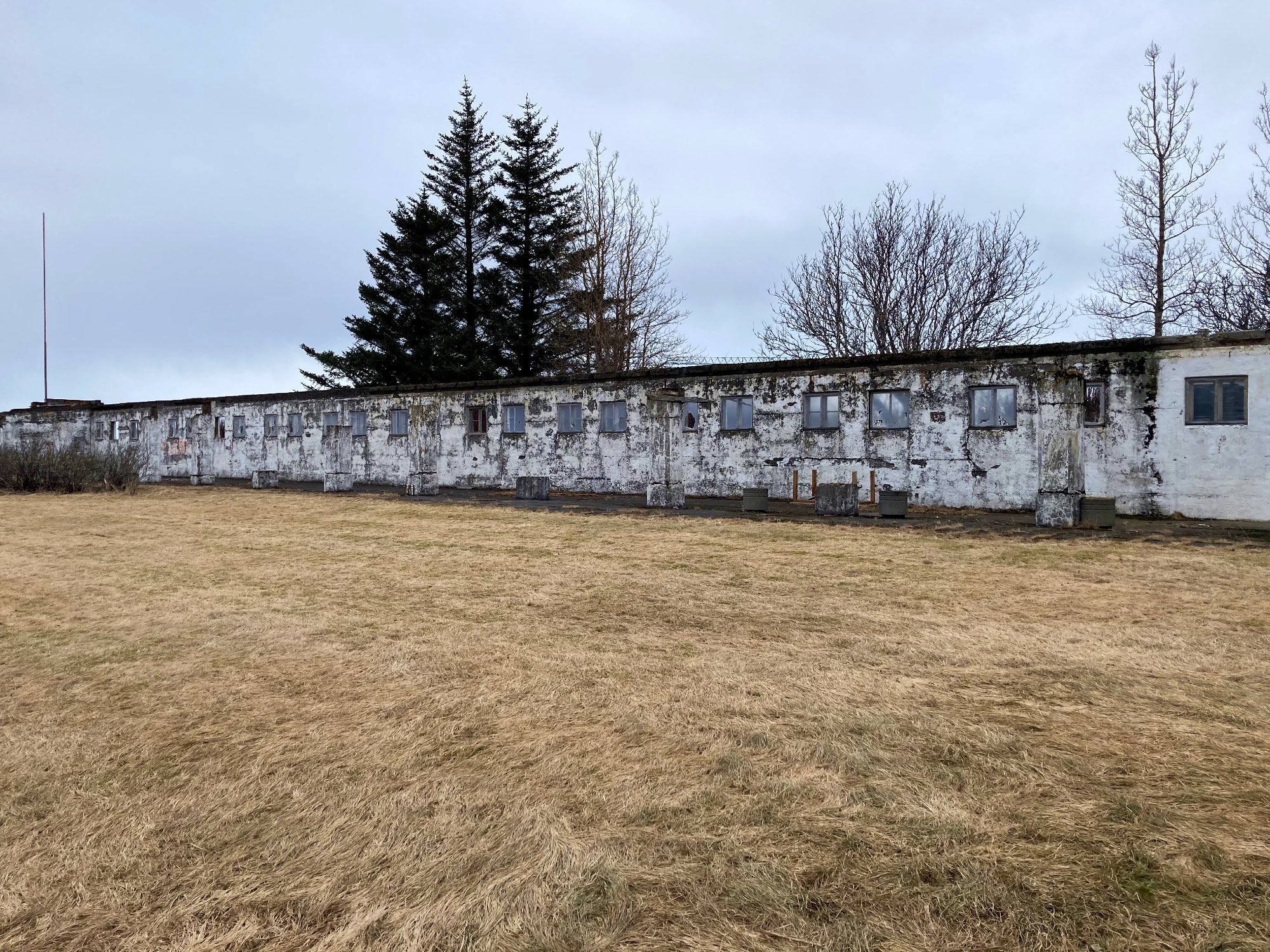 A long wall with small windows where tuberculosis patients used to sit for fresh air treatment.