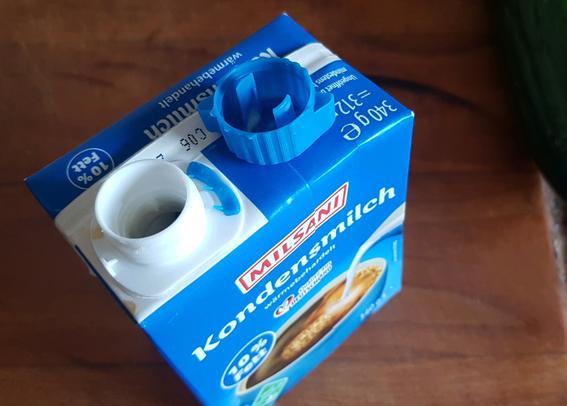 This recently acquired "TetraPak" of condense milk doesn't have a European "attached bottle cap"! I've bought this one in Germany, at Aldi Nord. Just a few weeks ago, those HAD attached caps! I remember the reasonable inconvenience quite clearly.