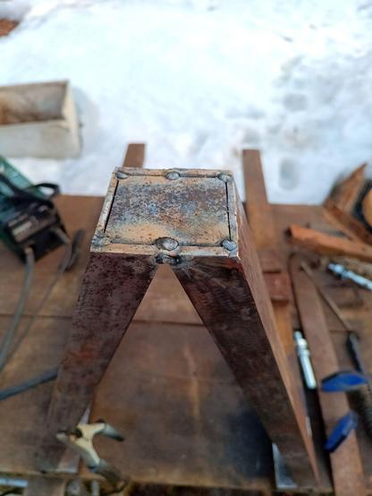 Top of the triangular frame. The triangle is tack-welded at the tips and a steel plate has been inserted into the gap between where the c-channels join and tack welded in six spots.