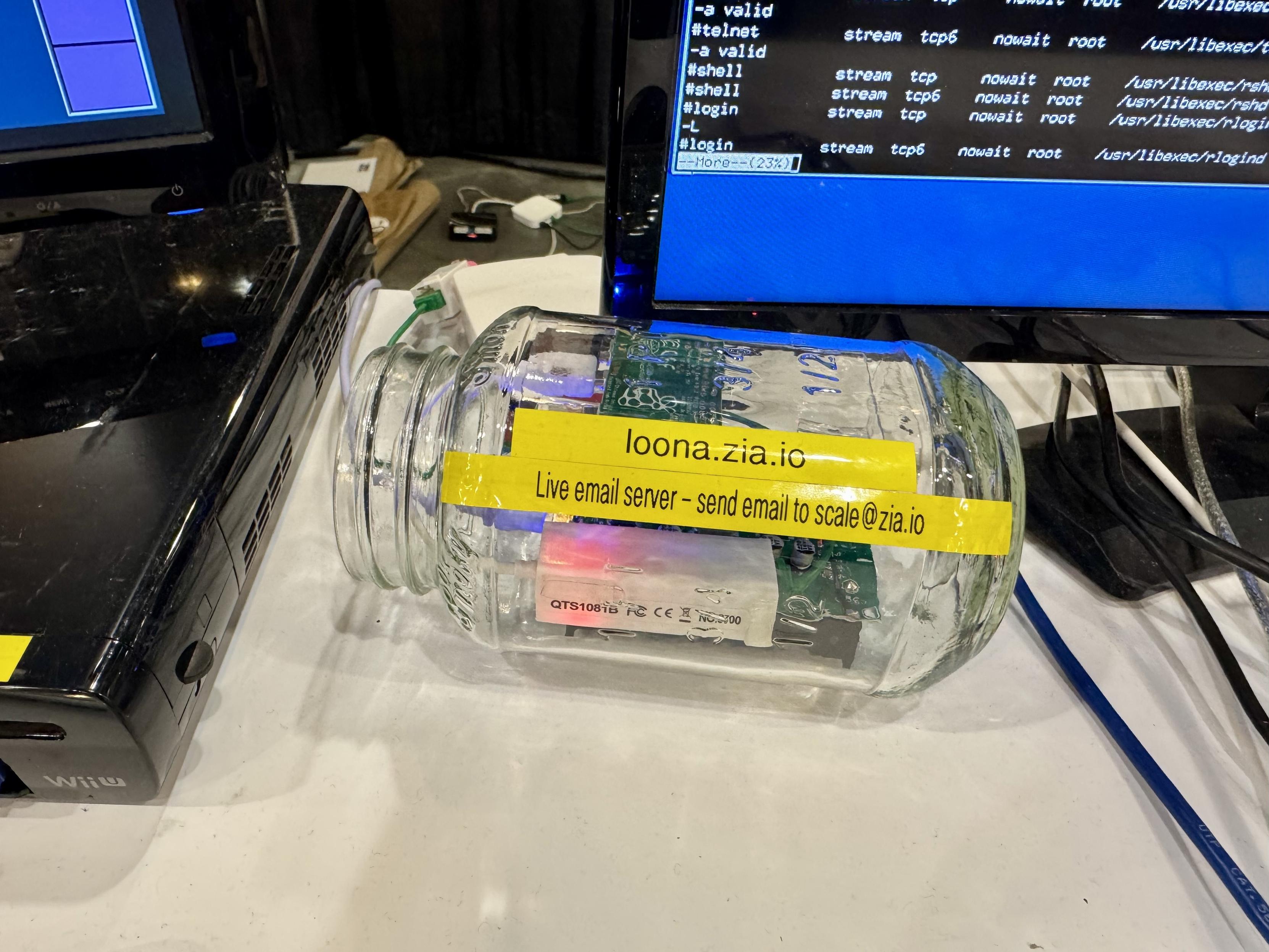 This is a picture of a Raspberry Pi Zero W built in to a nice glass jar which is running as a public email server that people could use in both directions right here at the expo.