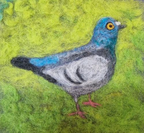 A very basic picture of a pigeon made of felt.