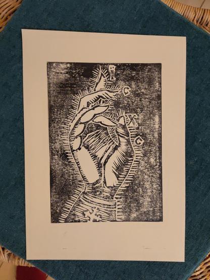 Photo of the first hand print on sand colored paper. The paper hasn't absorbed the ink so well. It has a kinda hazy worn look to it