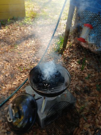 A small charcoal grill smoking away.