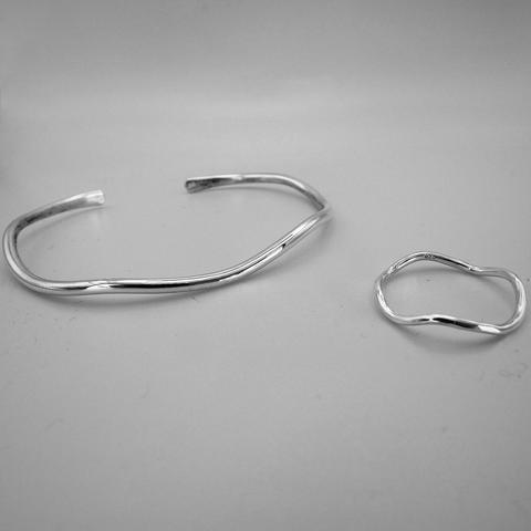 a wavy silver cuff bracelet and a similar ring