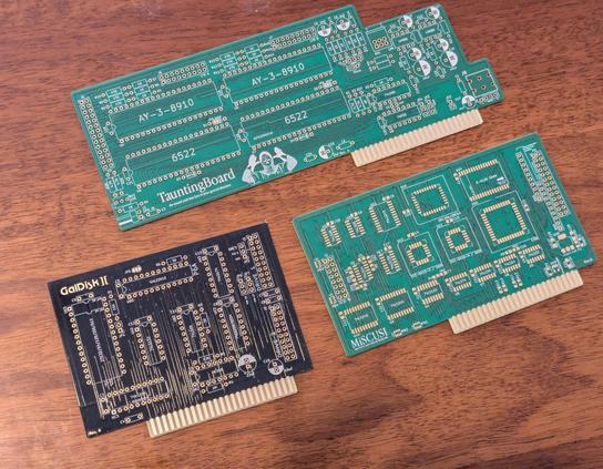 Photo of 3 PCBs. Two green ones, and a black one.
One of the greens is SMD, the rest are THT