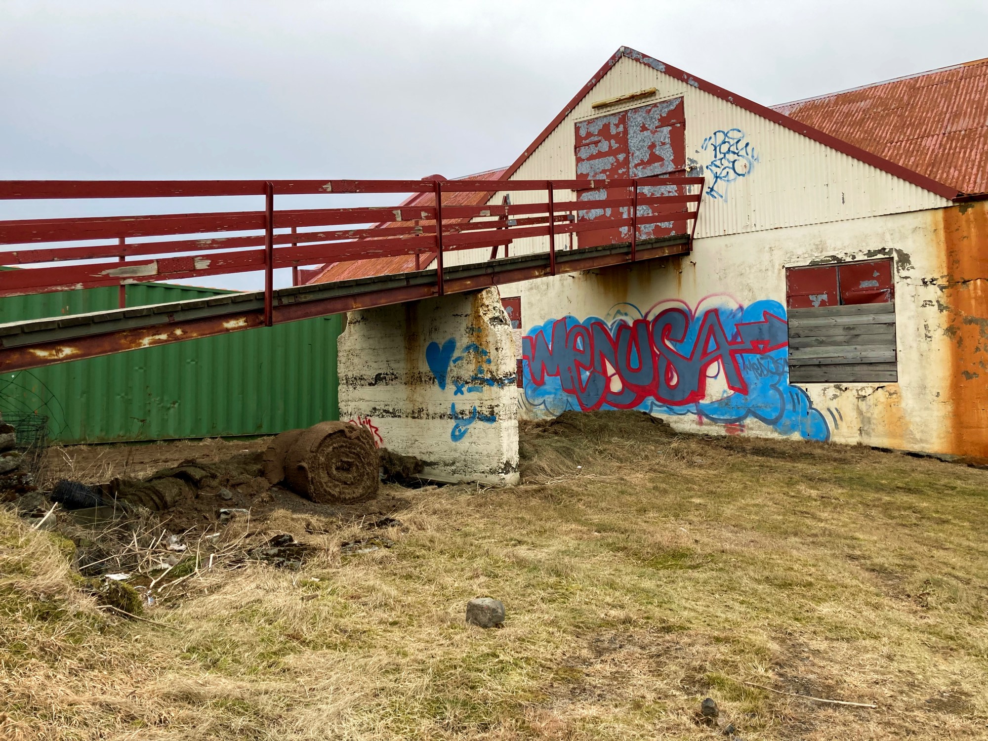 A large barn covered in graffiti.
