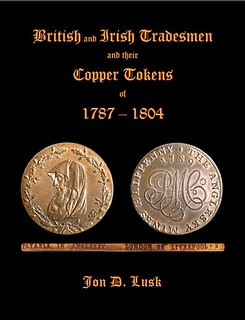 Book cover. Black book with a large copper token on it and the title "British and Irish Tradesmen and their Copper Tokens of 1787 - 1804 Jon D Lusk.