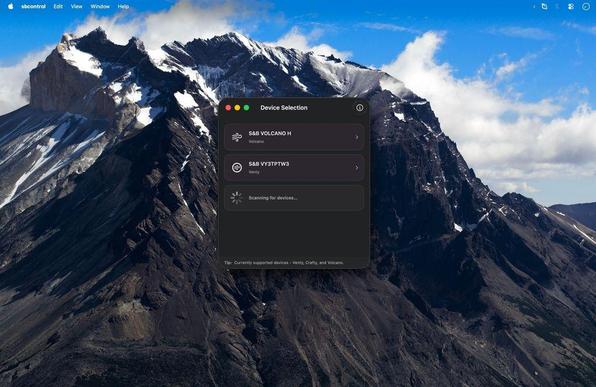 A macOS app window titled Device Selection listing available Bluetooth devices including S&B Volcano H and S&B VY3TPTW3 (Venty). A spinner indicates the app is scanning for additional devices. The interface sits on a macOS desktop with a mountain landscape wallpaper.