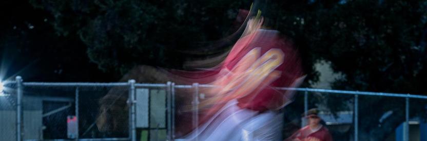 A surreal image of a basebal pitcher in a blur of motion.