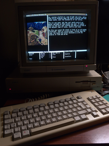 An Amiga 1000 running Frotz, an interpreter for classic Infocom textadventures. On screen you can see the opening of Journey, a late experiment in graphical adventure games.