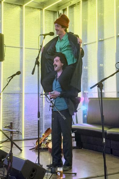 Johnny Franco sitting on the shoulder of his brother Dom before performing
