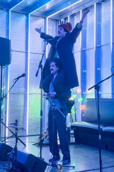 Johnny Franco sitting on the shoulder of his brother Dom before performing