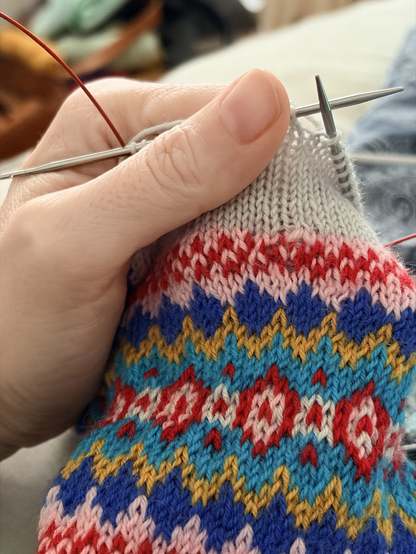 Colorwork sock with a visible irregularity where I dropped stitches.