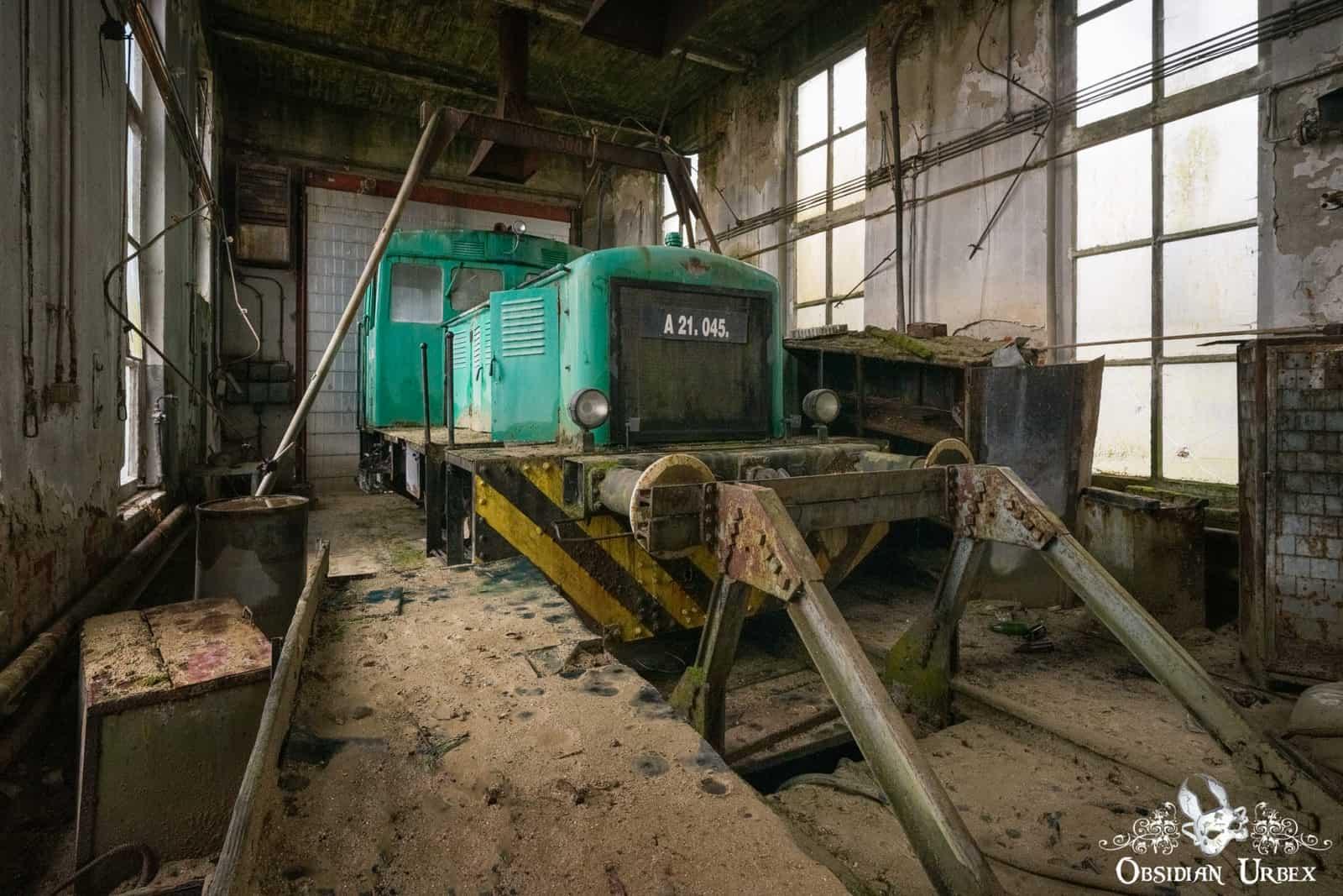 An old M28 series locomotive, first produced in 1955 by the Hungarian Wagon and Machine Works in Győr. Mostly they serviced industrial railways, moving loads and freight. This one worked at a now abandoned thermal power plant in Hungary. Now it sits silent and forgotten inside an old rail shed.