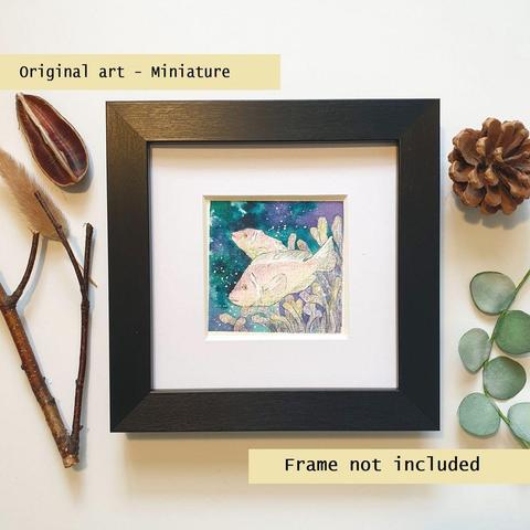 A tiny painting of pale pink anemone fish with a dark ocean background.
An original art work, please note that the frame is not included.
Watercolour and mixed media on white acid free artist watercolour paper.
Approximately 7.5 x 7.5cm, will fit a 3 x 3 inch photo frame.