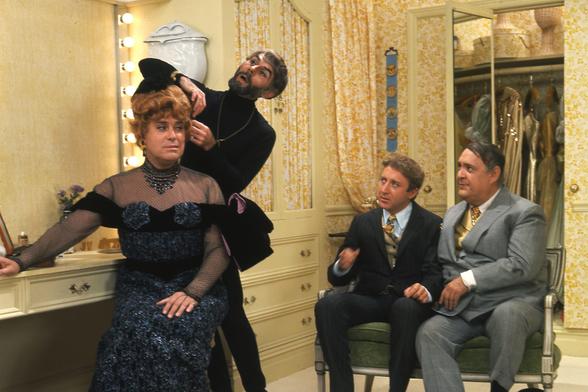 Screenshot from The Producers. Characters from left are: worst director in the world director Roger DeBris, his assistant/lover Karmann Ghia, Leo Bloom, and Max Bialystock.