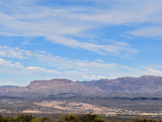 Sombrero Butte and the Galiuro mountains under a blue afternoon sky