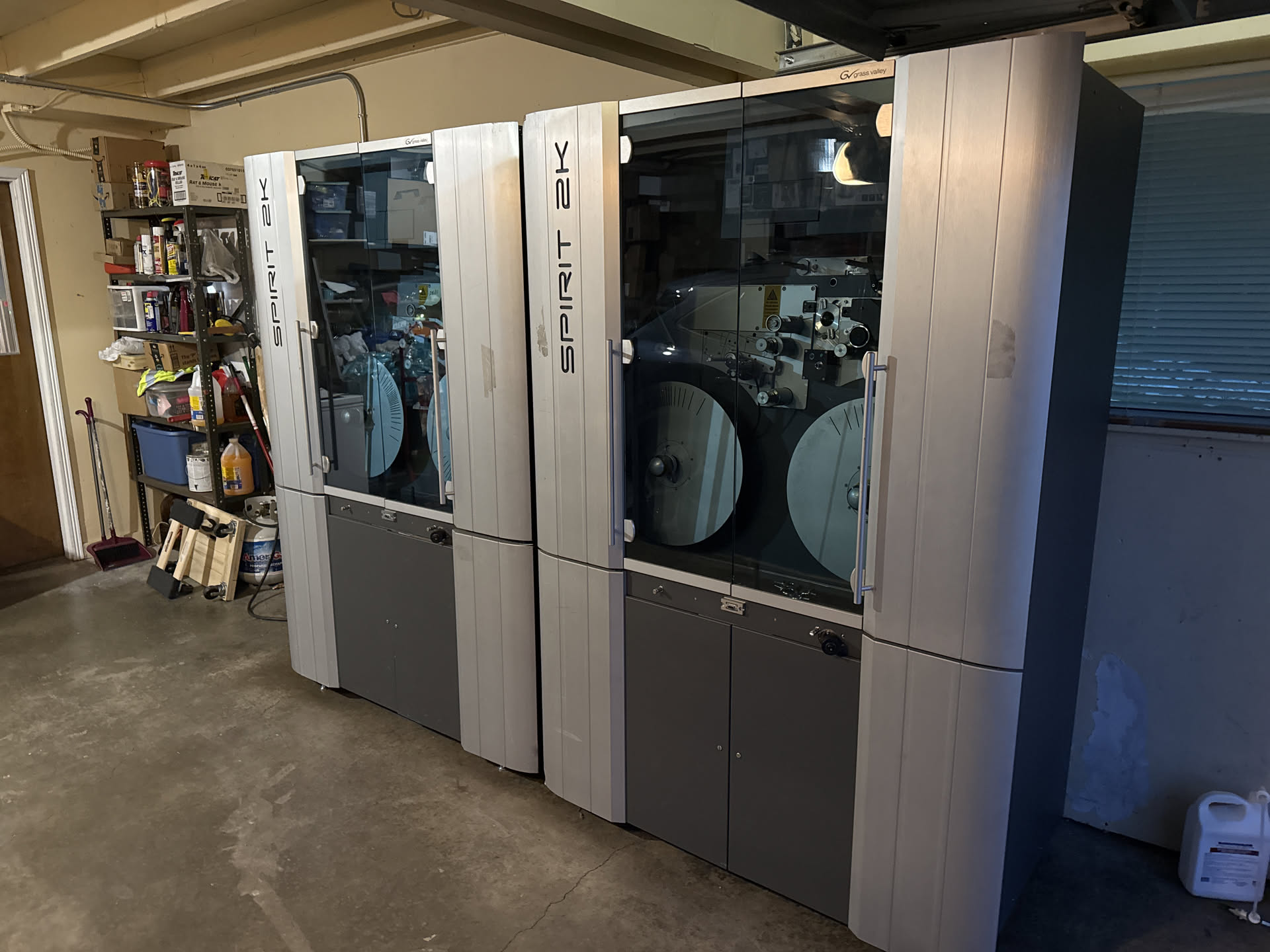 a big set of Spirit 2K film scanners. they look cool as fuck. they're beautiful brushed stainless steel on the sides and a big glass view door to watch the film transport mechanims they're in a garage