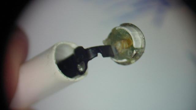 A open airpod without battery. The black FPC cable is missing a piece in the center. Its broken and cannot reasonably be repaired.