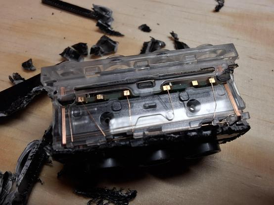 The Smart Brick opened up with its transparent block. A lot of black brittle in the background.