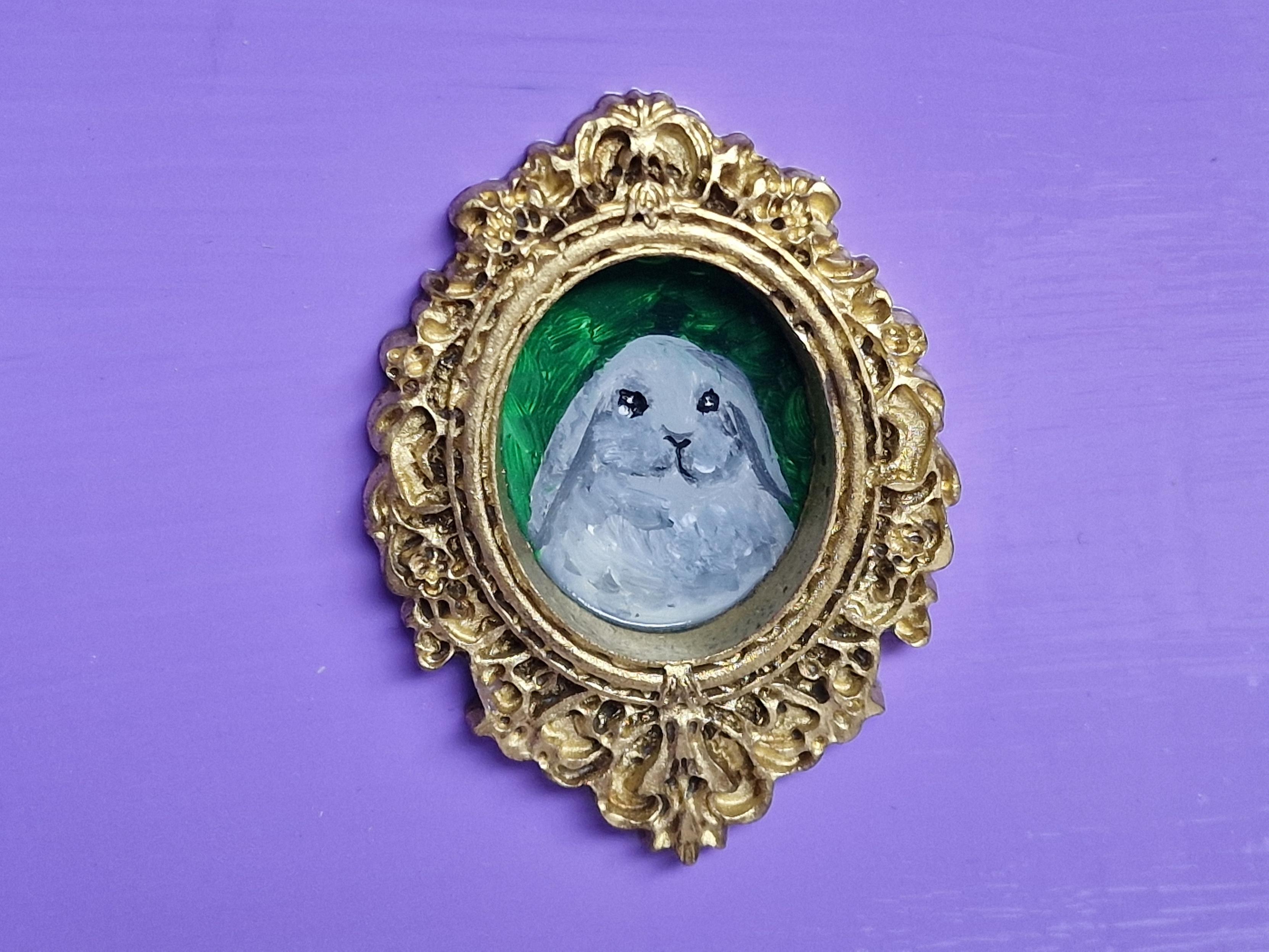 Tiny portrait of my little grey lop eared bunny, Egg, in a gold frame