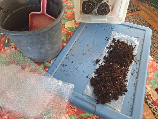 Seed starting mix is spread onto a plastic sheet