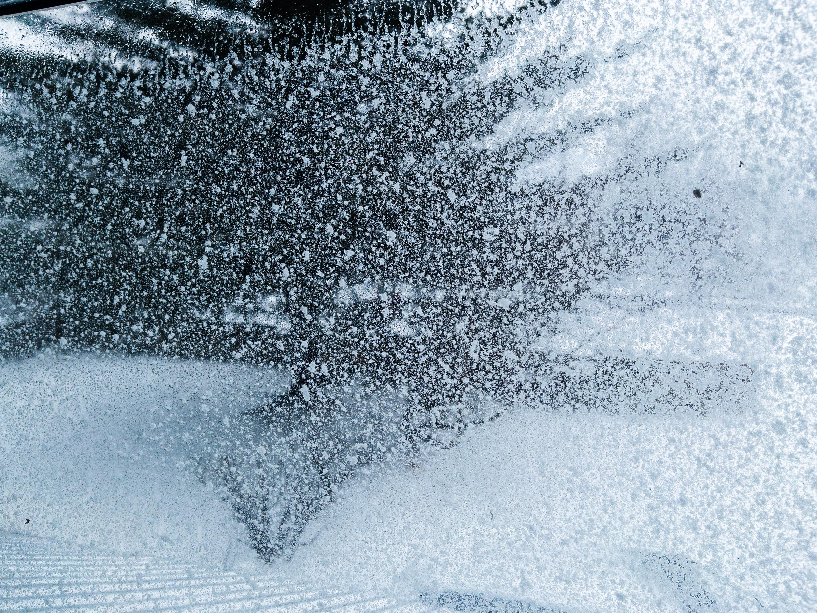 A window covered in snow. The outside is all snow as well