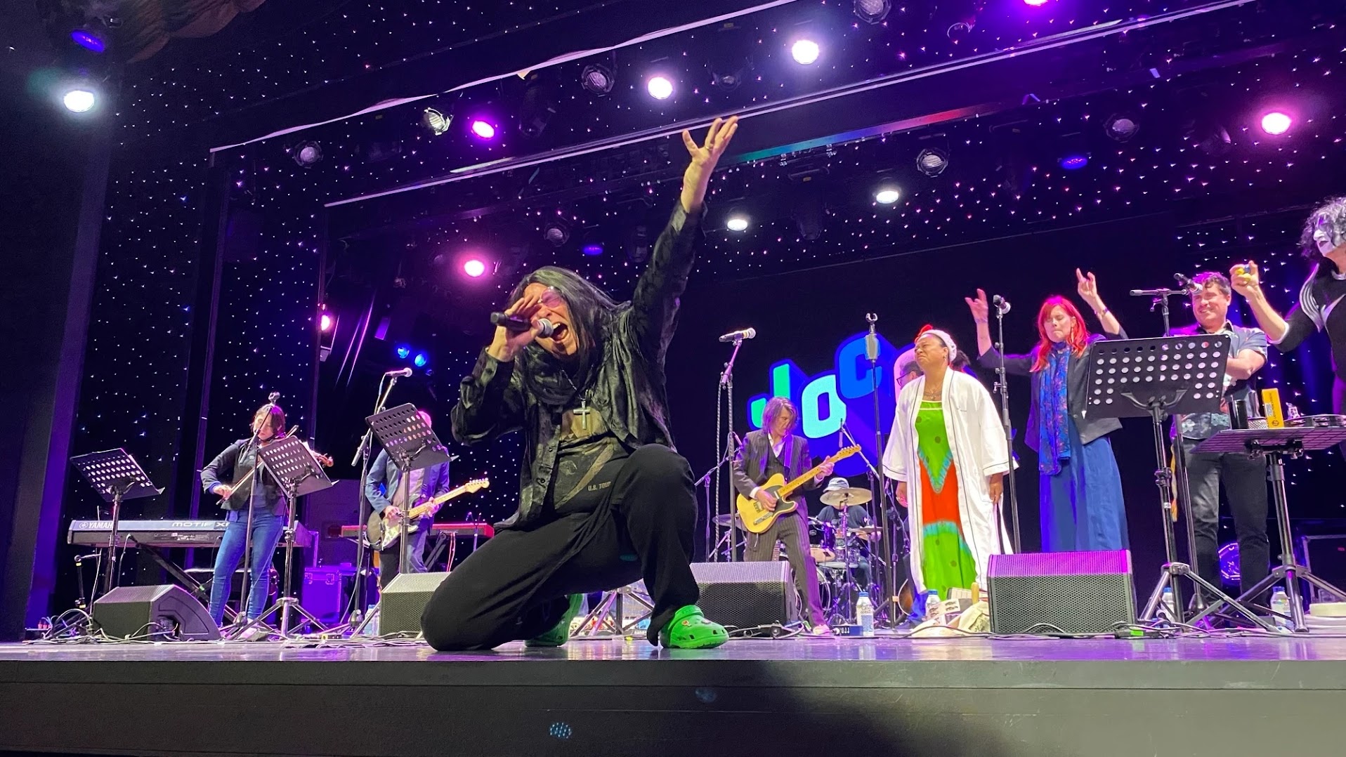Me on the stage of the JoCo Cruise, singing Crazy Train and acting like a complete ham, complete with long black wig.